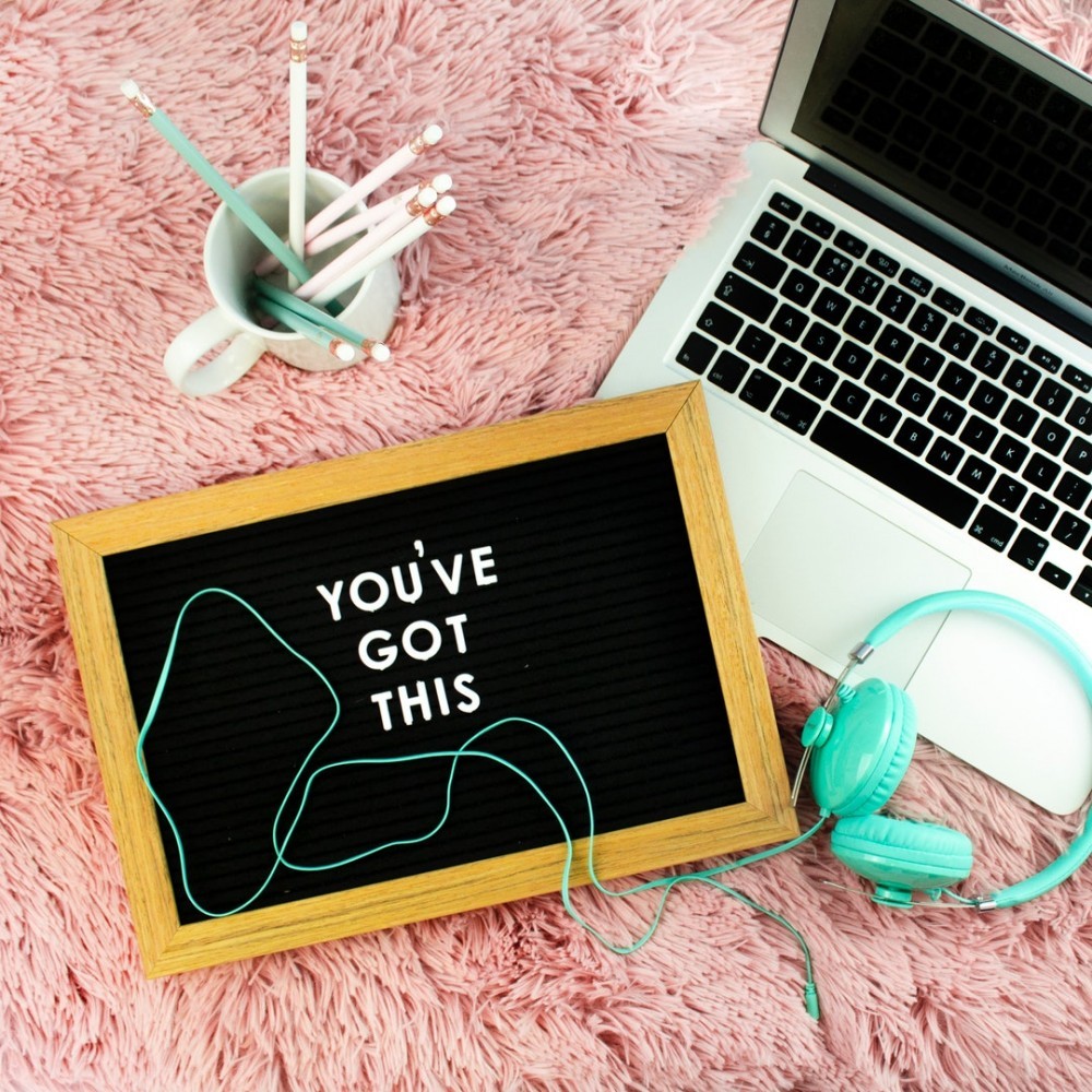 laptop, pencil, and green earphones