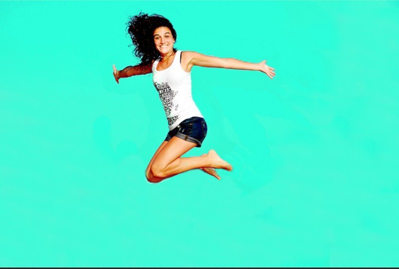 girl jumping on a green background