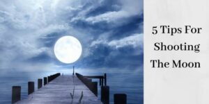 full moon over dock of lake